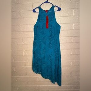 Jennifer Lopez Teal Garment with Vibrant Red Accents